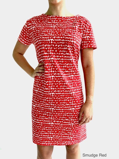 A woman wearing a comfortable red See Design Knit Dress Short Sleeve.