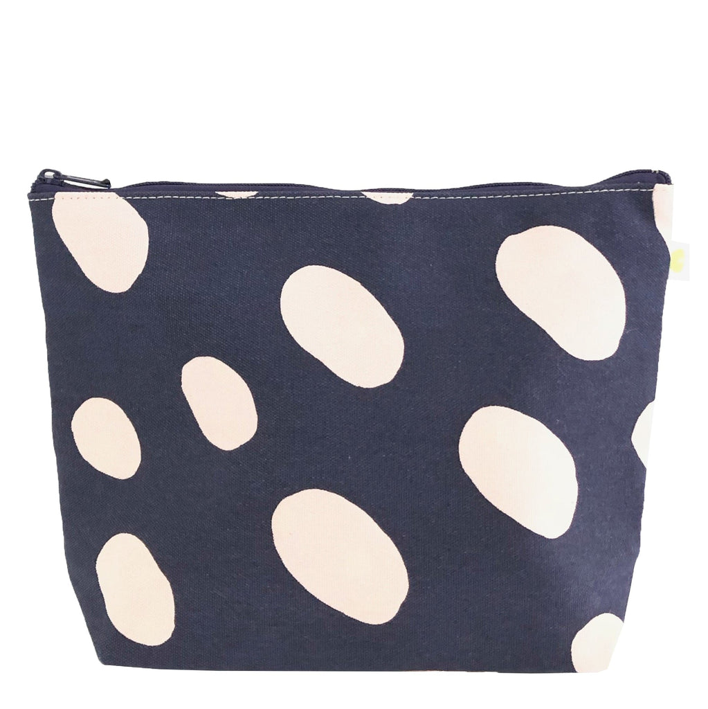 A navy and white polka dot See Design Travel Pouch Extra Large.