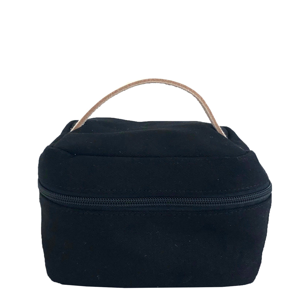 A black Train Case Small cosmetic bag with a leather handle, perfect for travel. Brand name: See Design.