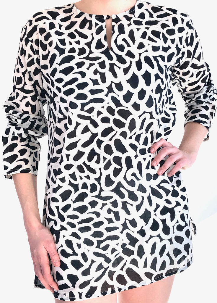 A woman wearing a lightweight See Design animal print tunic made of cotton voile.