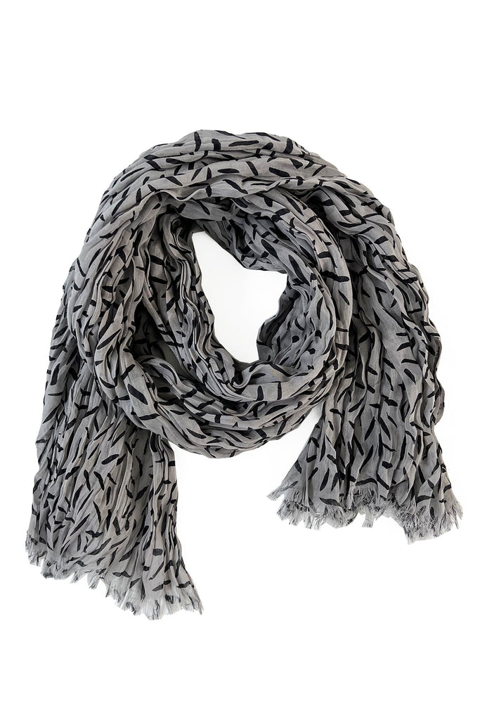 A lightweight See Design cotton scarf with a black and white pattern.