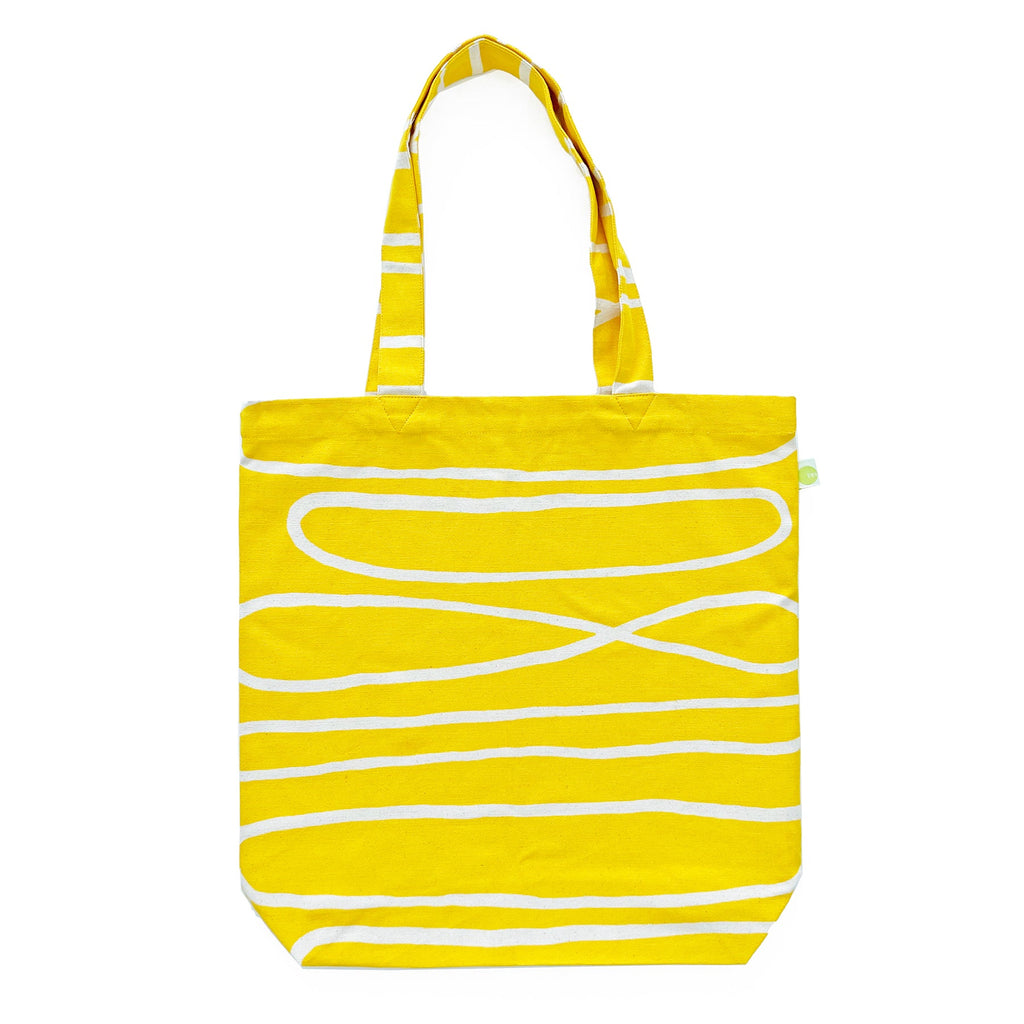 A lightweight, cotton canvas tote bag in yellow with white stripes, the Easy Tote Bag by See Design.