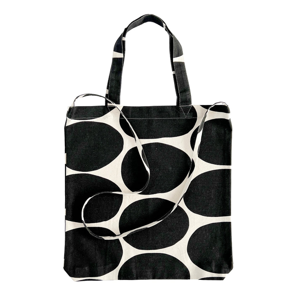 A lightweight Easy Tote Crossbody Bag by See Design with a black and white polka dot pattern.