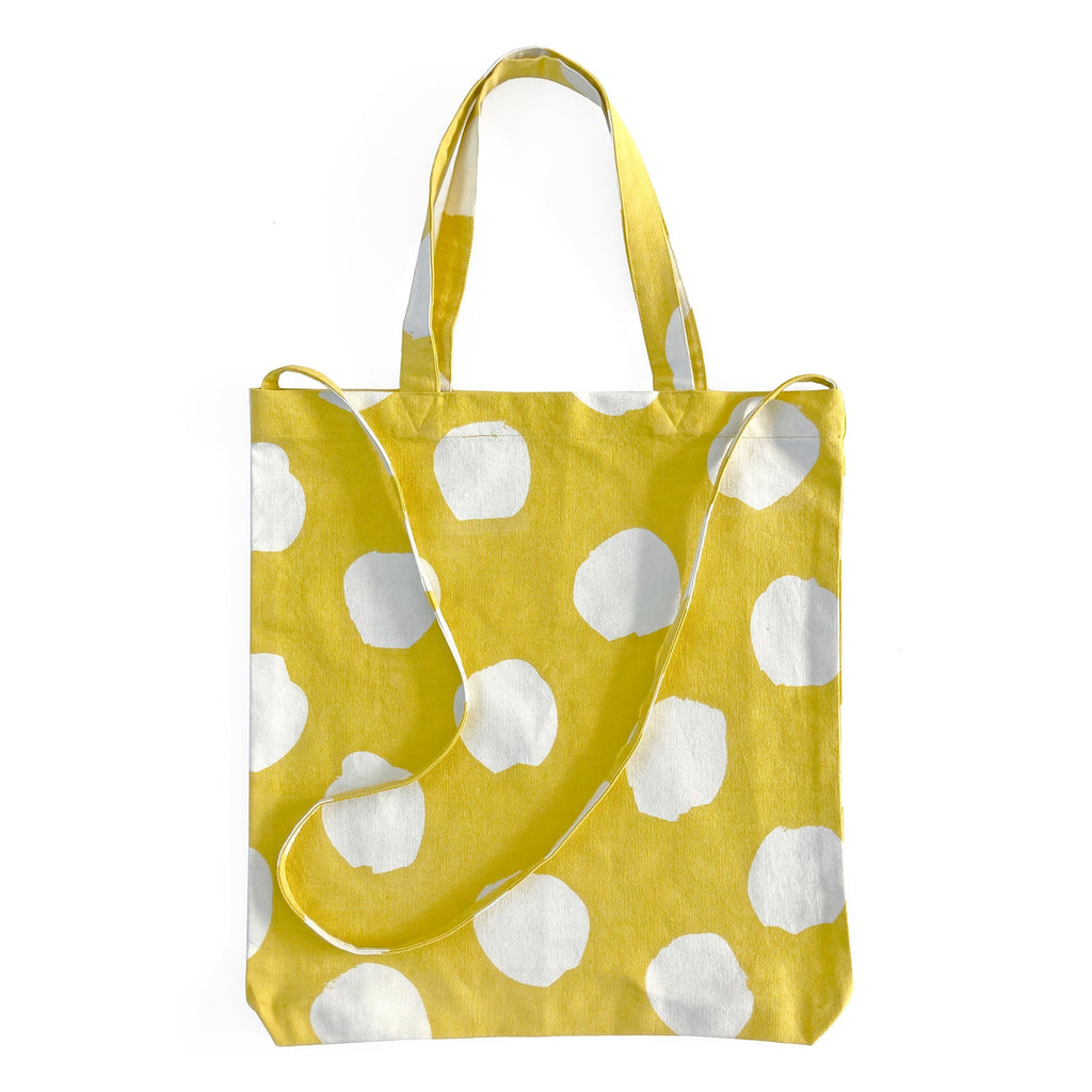 A lightweight yellow and white polka dot Easy Tote Crossbody Bag by See Design.