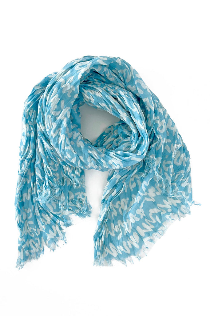 A lightweight, blue and white See Design cotton scarf on a white background.