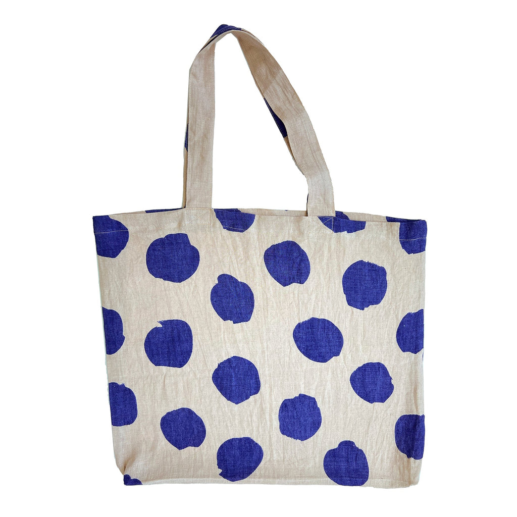 A lightweight Linen Everyday Tote Bag with hand painted blue and white polka dot designs by See Design.