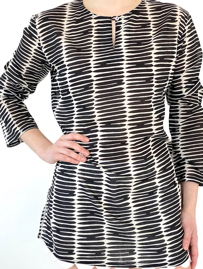 Versatile woman in a lightweight See Design black and white striped tunic made from cotton voile.