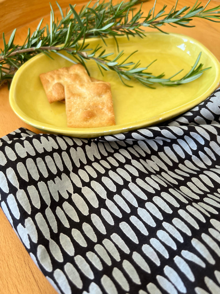 A set of 4 See Design napkins with hand painted designs and a rosemary sprig on it.
