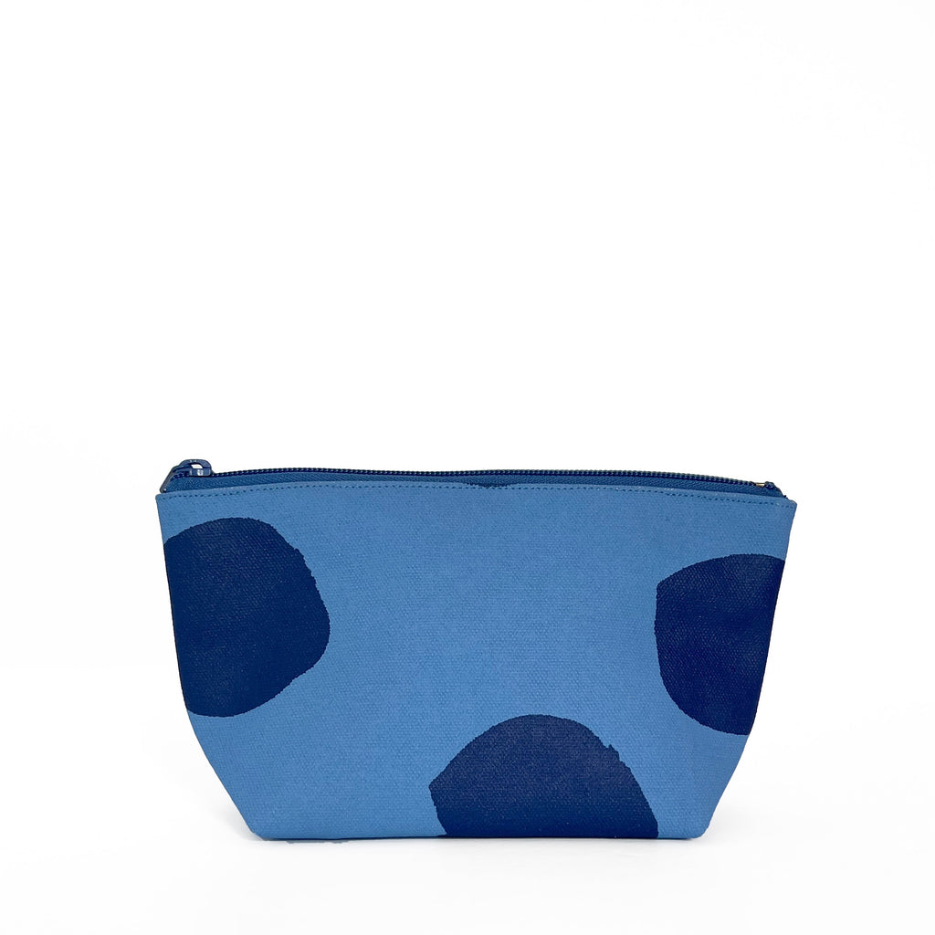 A Travel Pouch Small with a blue cotton canvas exterior by See Design.