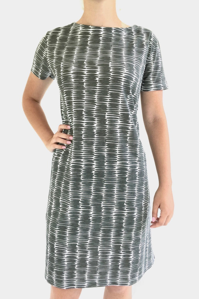 A comfortable and versatile woman wearing a grey and white striped See Design Knit Dress Short Sleeve.