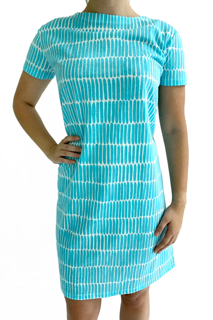 A woman is posing in a comfortable turquoise See Design Knit Dress Short Sleeve.