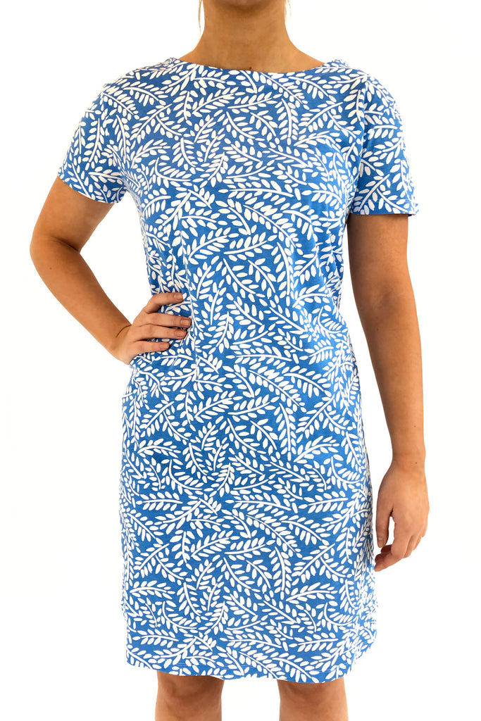 A woman wearing a comfortable See Design blue and white knit dress short sleeve.