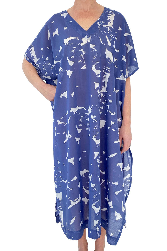 A woman in a flowing See Design caftan long beach cover up.
