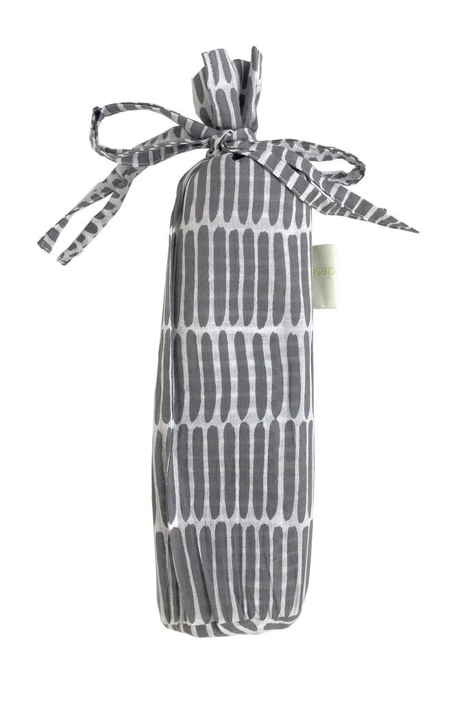 A fashionable Sarong bag made of lightweight cotton, with a ribbon tied around it. Brand Name: See Design