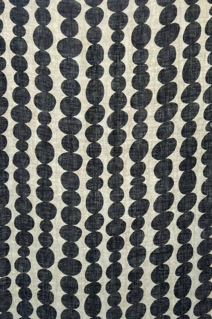 A modern black and white See Design linen scarf adorned with playful dots.