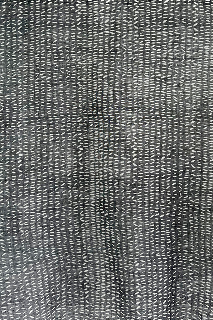 A Wool Scarf - See Design with white dots on a black and white background.
