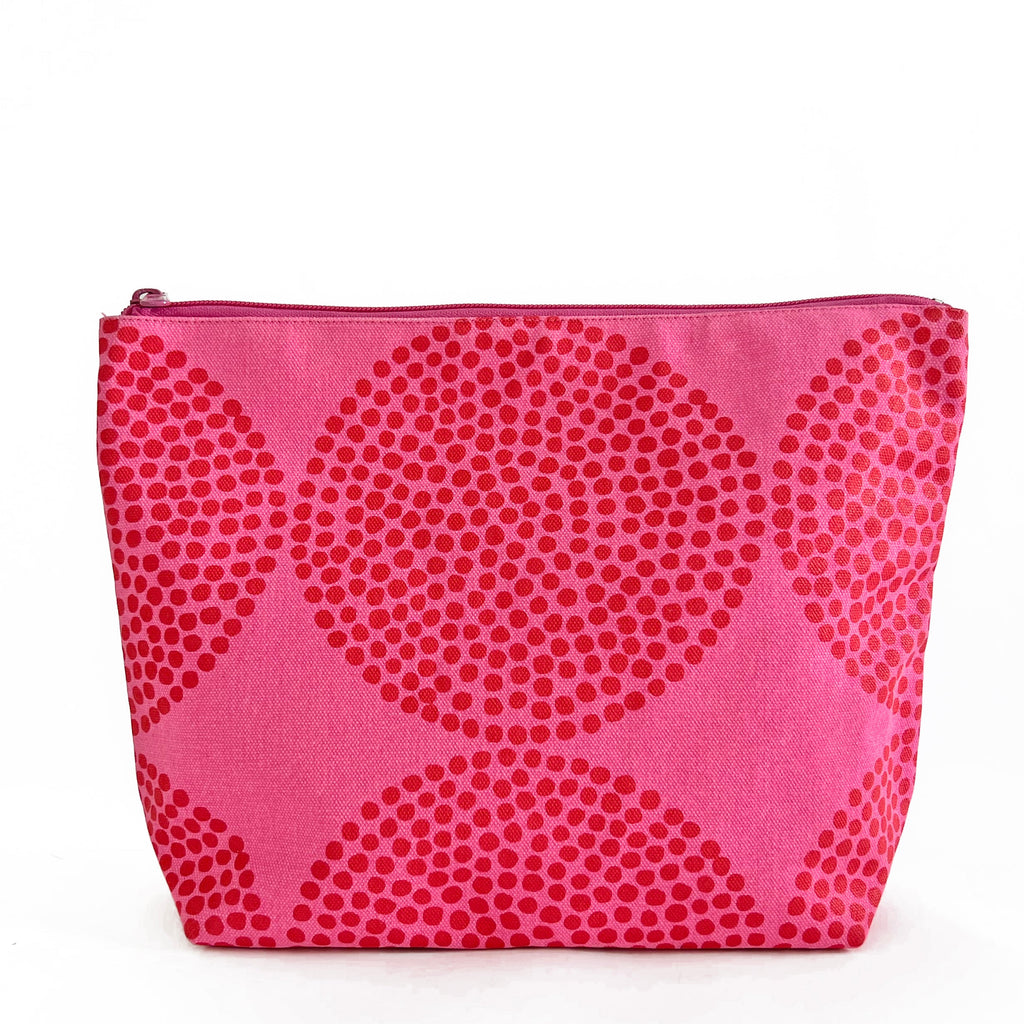 An extra large pink Travel Pouch Extra Large with polka dots on it, perfect for travel storage.