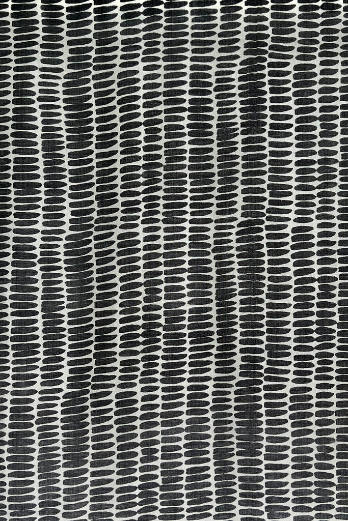A black and white patterned Wool Scarf on a wall, by See Design.