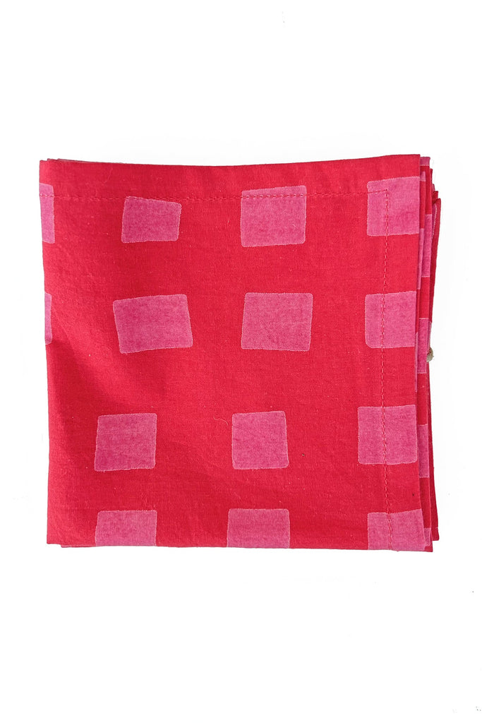 A set of four red Cocktail Napkins from See Design featuring a pattern of evenly spaced pink rectangles, perfect as colorful table linens.