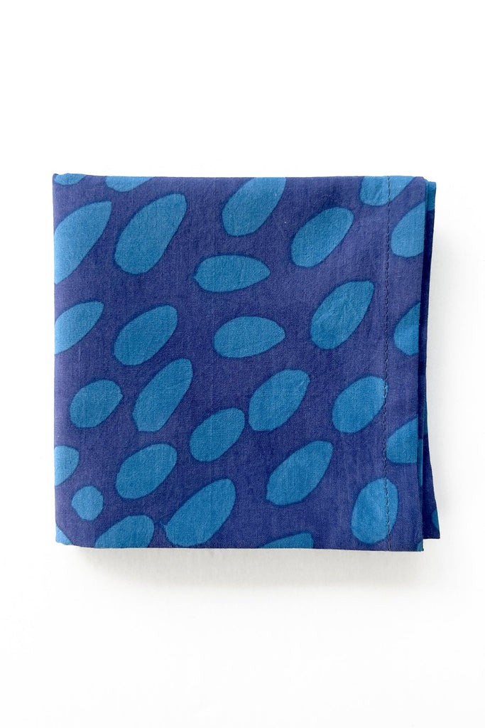 See Design's Cocktail Napkins, a set of four, feature hand-painted blue patterns of light oval shapes on a white background, adding an artistic touch to your table setting.