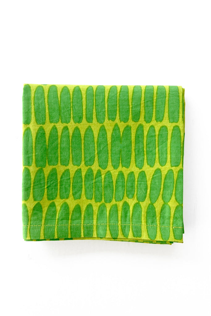 The Cocktail Napkins (Set of 4) by See Design feature green cloth with charming hand-painted oval patterns, beautifully folded against a white background.