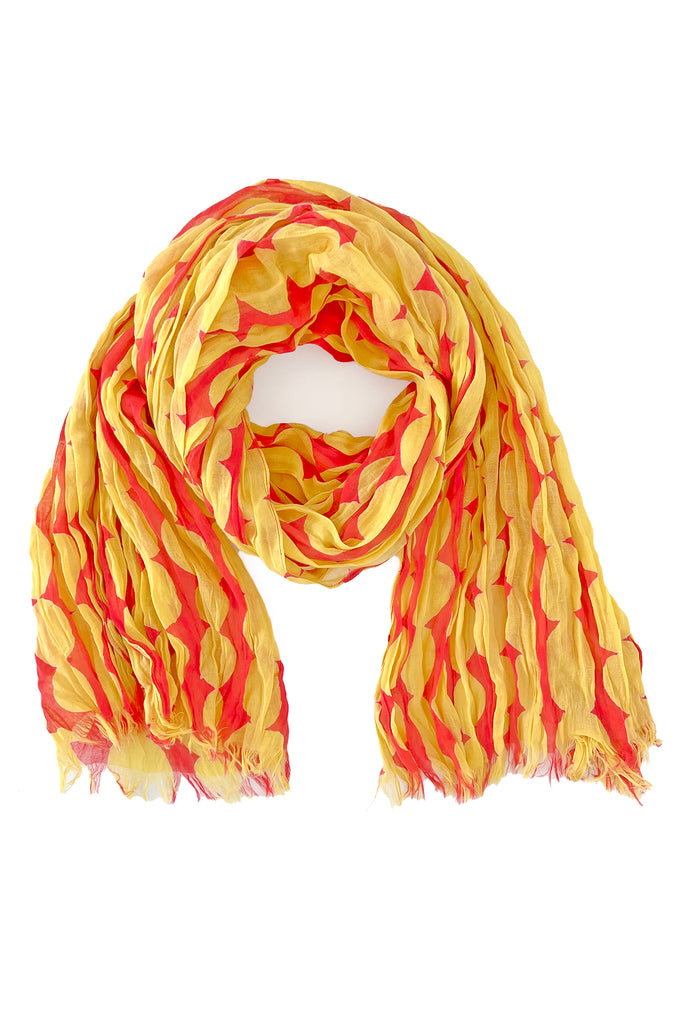 The See Design Cotton Scarf is lightweight with a crinkled texture, yellow and red leaf pattern, and fringed edges—ideal for fans of stylish crinkled scarves.