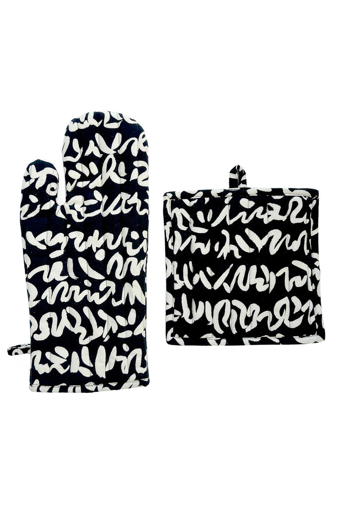 The Oven Mitt & Potholder Set by See Design features a black and white abstract design on a white cotton fabric background.