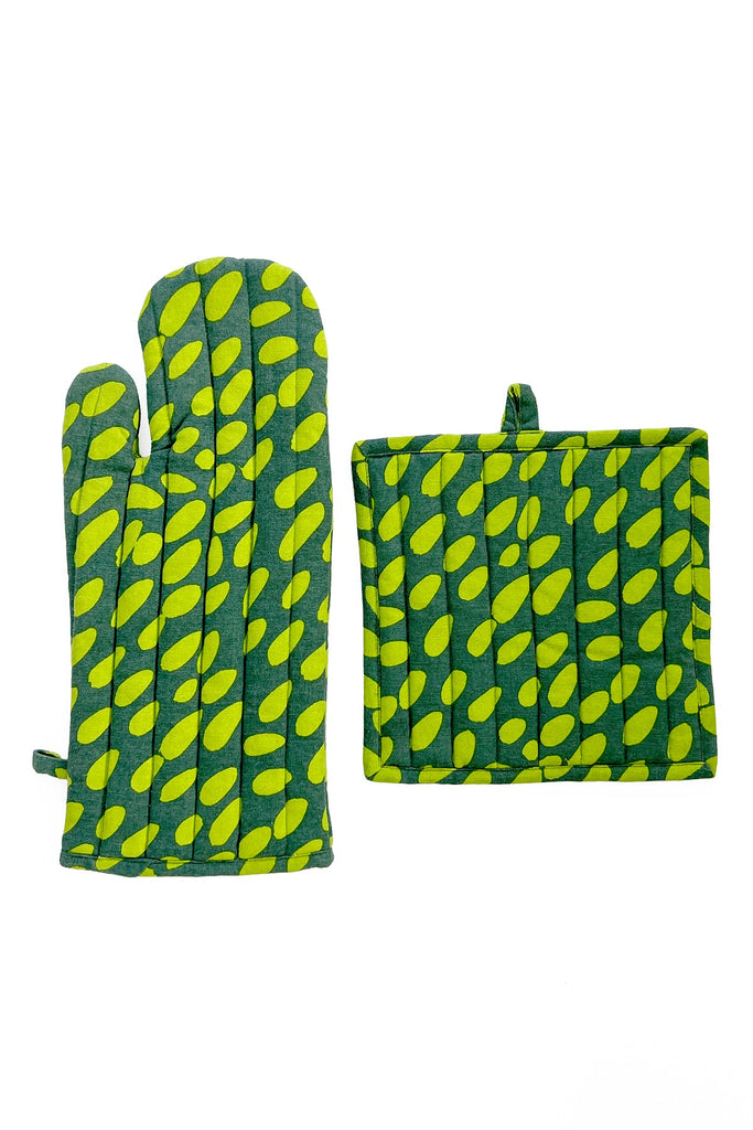 A green Oven Mitt & Potholder Set by See Design, made from cotton fabric adorned with yellow leaf patterns, is displayed against a white background.