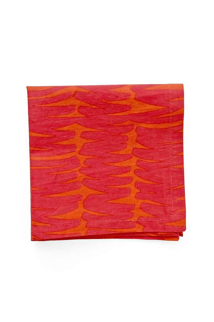 The Cocktail Napkins (Set of 4) by See Design, featuring orange and red abstract wavy lines, create striking and colorful table linens that stand out.