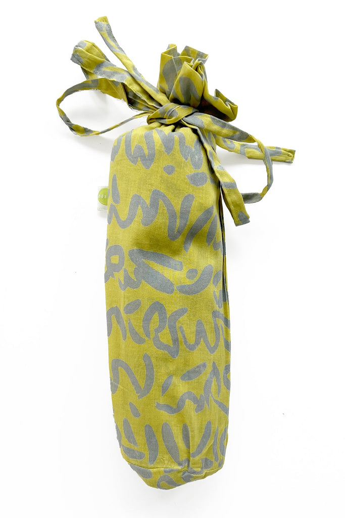 A fashionable Sarong bag made of lightweight cotton, with a ribbon tied around it. Brand Name: See Design