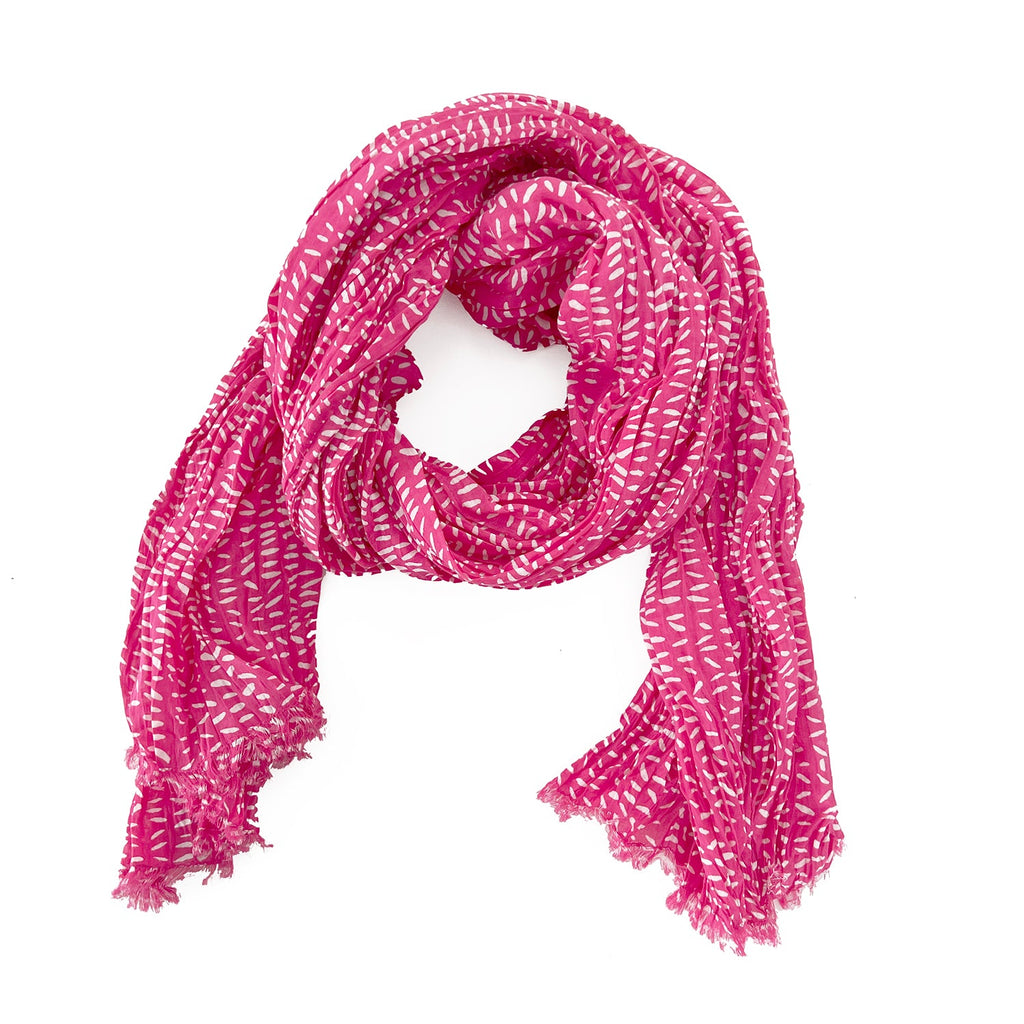 A woman wearing a See Design lightweight cotton scarf.