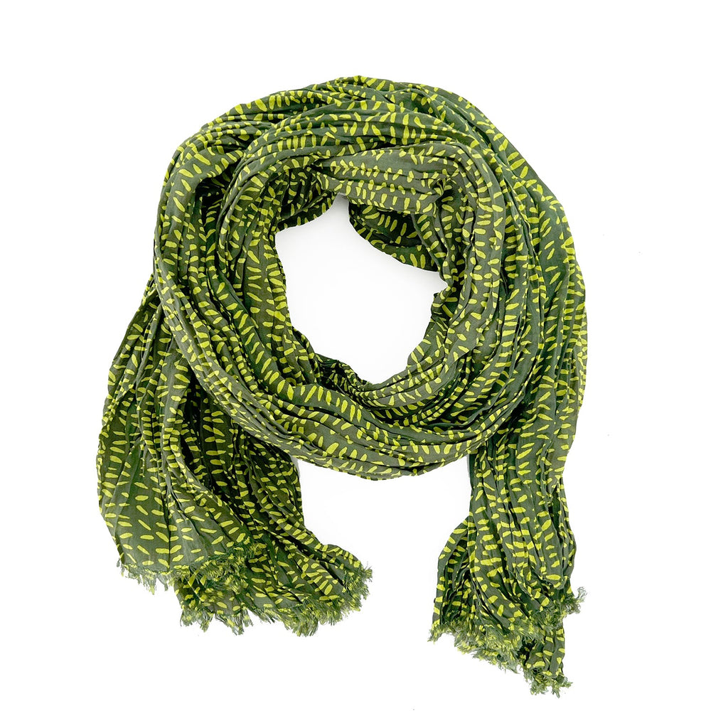 A woman wearing a See Design lightweight cotton scarf.