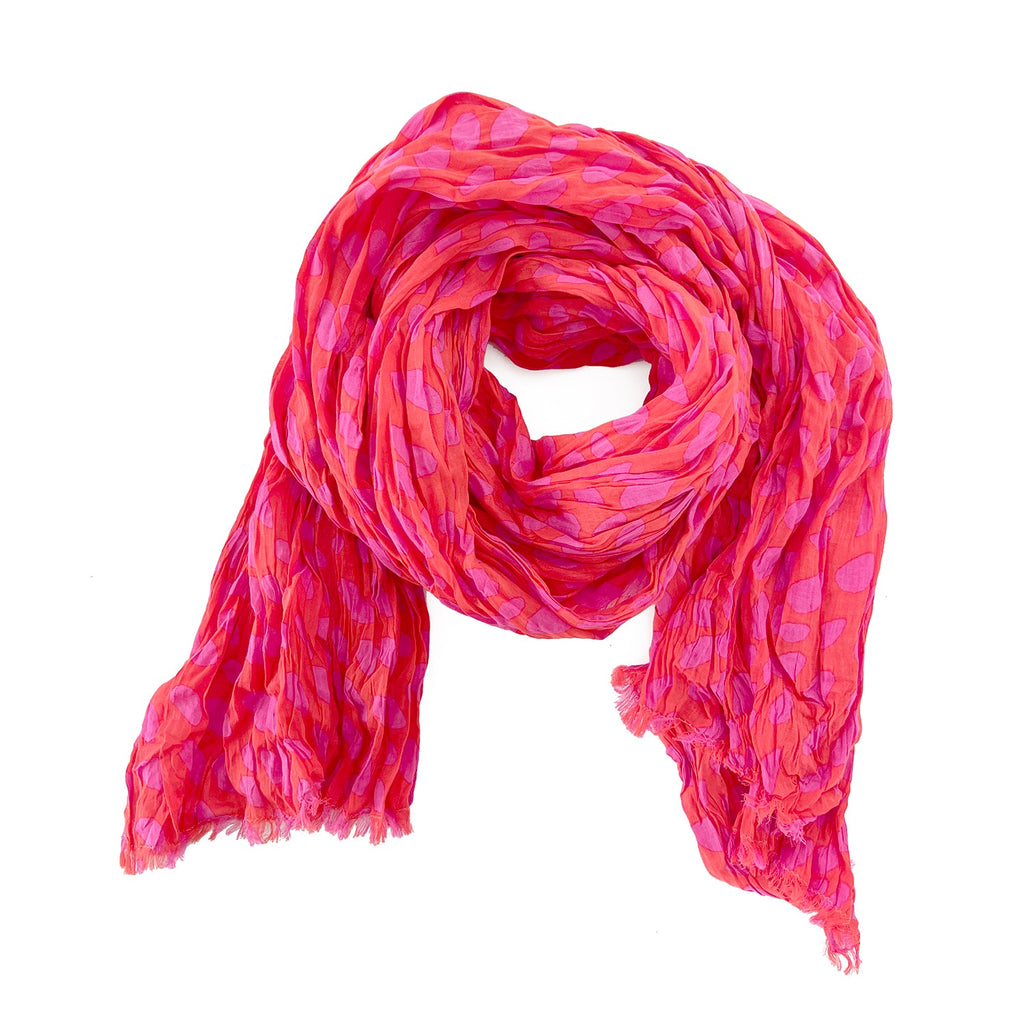 A woman wearing a See Design lightweight cotton scarf.