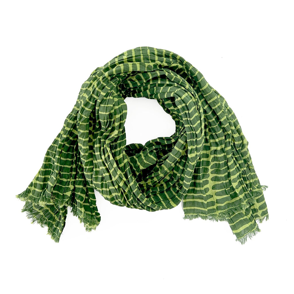 A woman wearing a See Design lightweight cotton scarf.