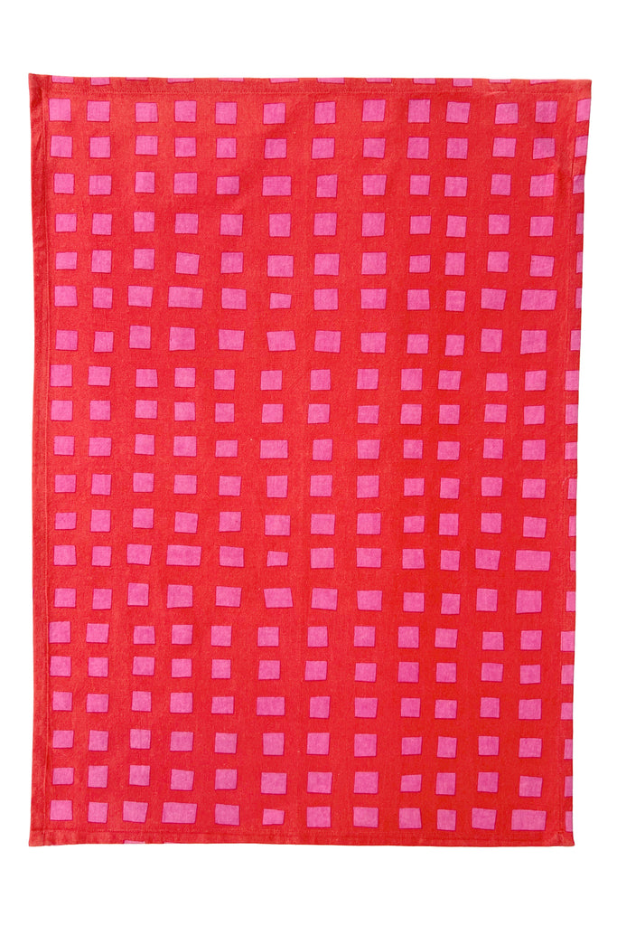 See Design's Tea Towels (Set of 2) feature a red square cotton cloth with evenly spaced pink rectangles in vertical columns, echoing Donna Gorman’s style—perfect for adding a stylish touch to your kitchen.