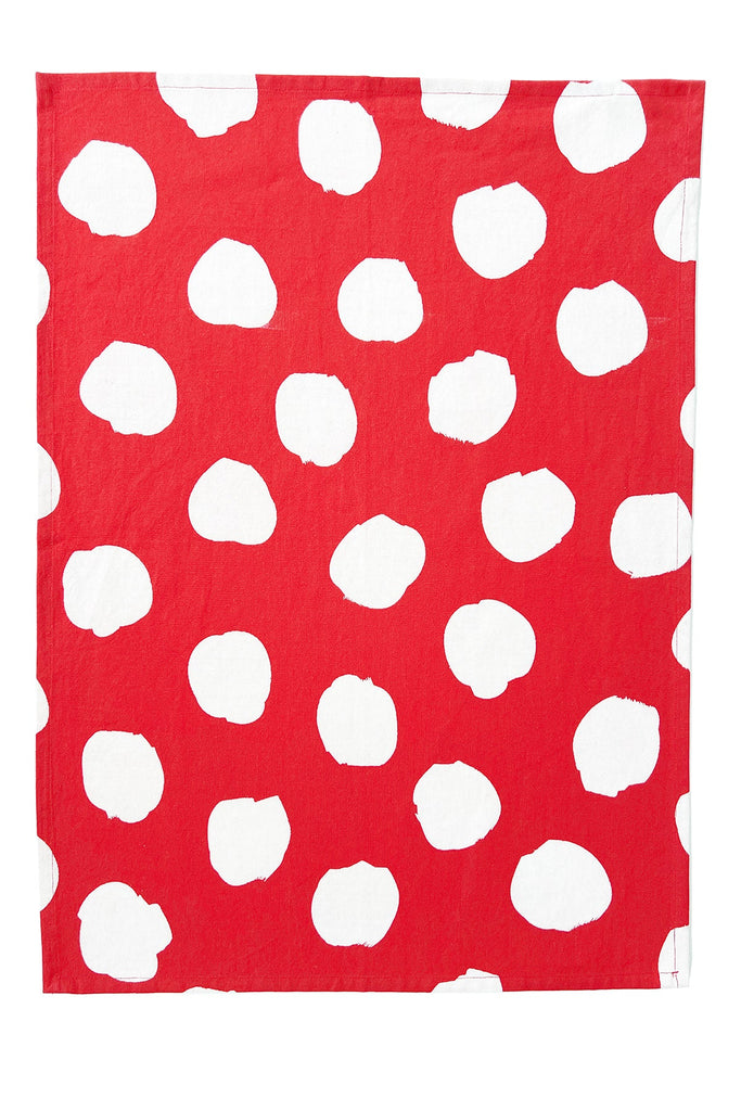 This set of 2 cotton tea towels from See Design features a square red cloth with an irregular white polka dot pattern, showcasing Donna Gorman’s playful style for your kitchen.