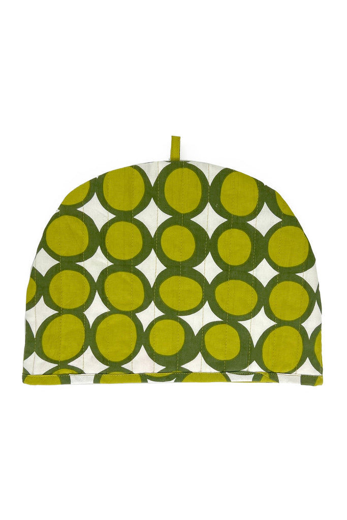 The See Design Tea Cosy features a green and white geometric circular pattern, a small top loop, and is part of our fall home collection.