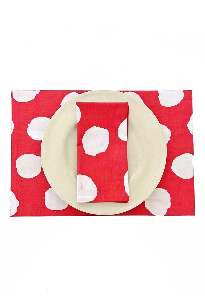 A beige plate and napkin sit on See Design Placemats (Set of 2) featuring large white polka dots, arranged on a white background.