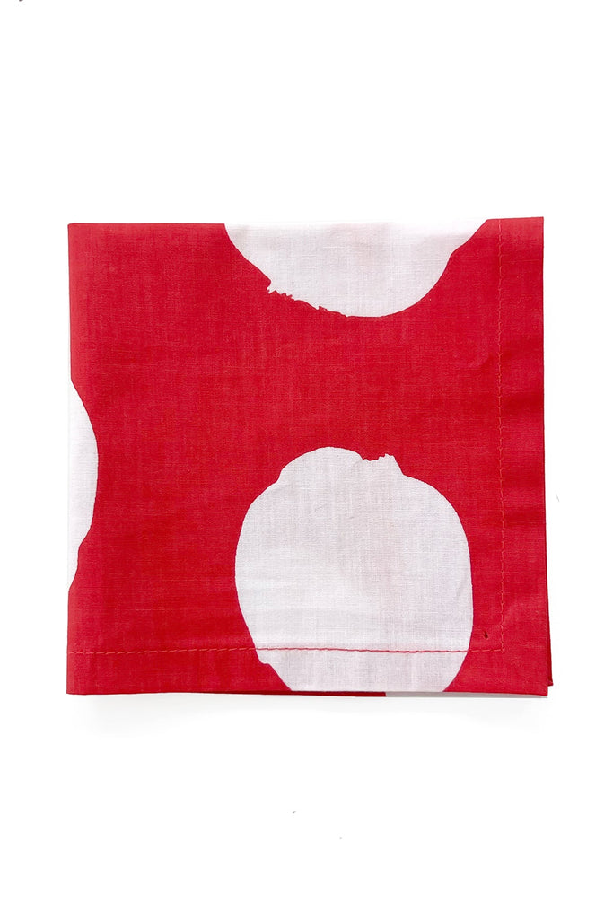 The See Design Cocktail Napkins (Set of 4) feature a bold red cotton fabric with large white circles, neatly folded against a white background—perfect for adding vibrant style to your table.