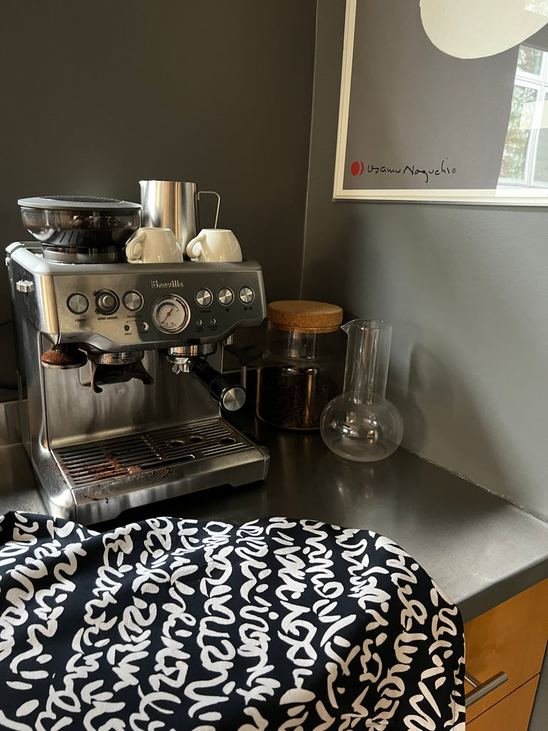 A black and white See Design coffee machine on a kitchen counter.