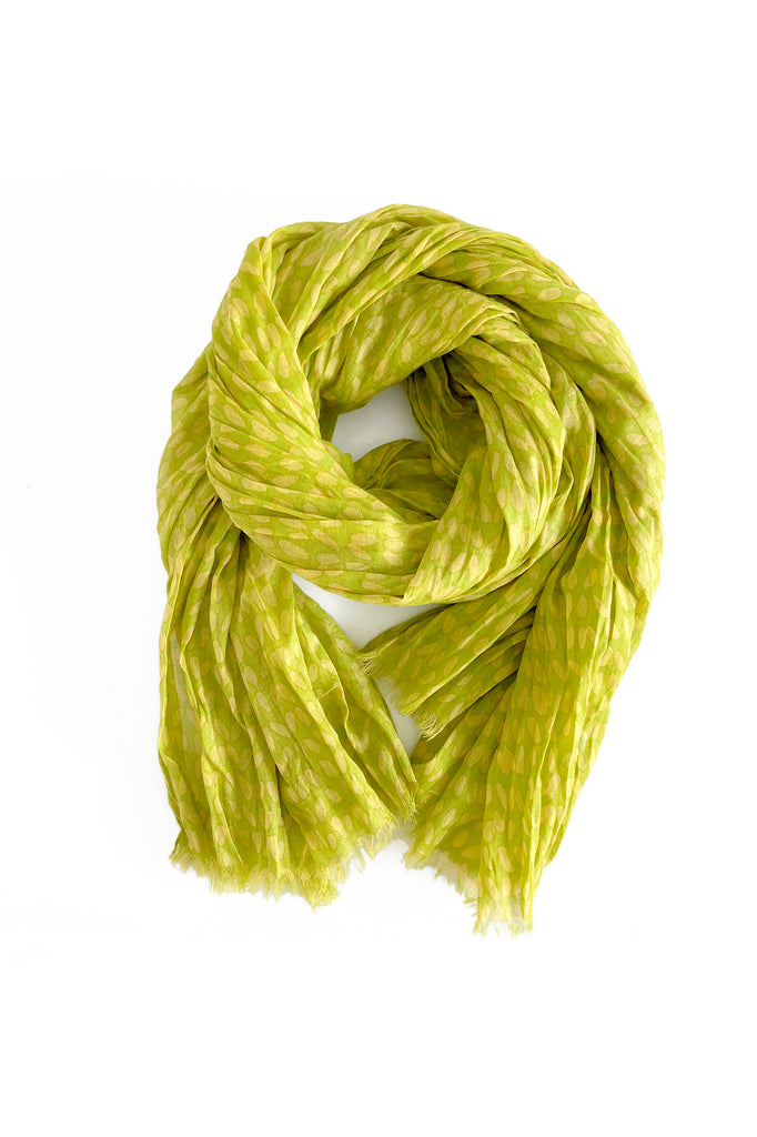 A lightweight cotton scarf in lime green on a white background from See Design.