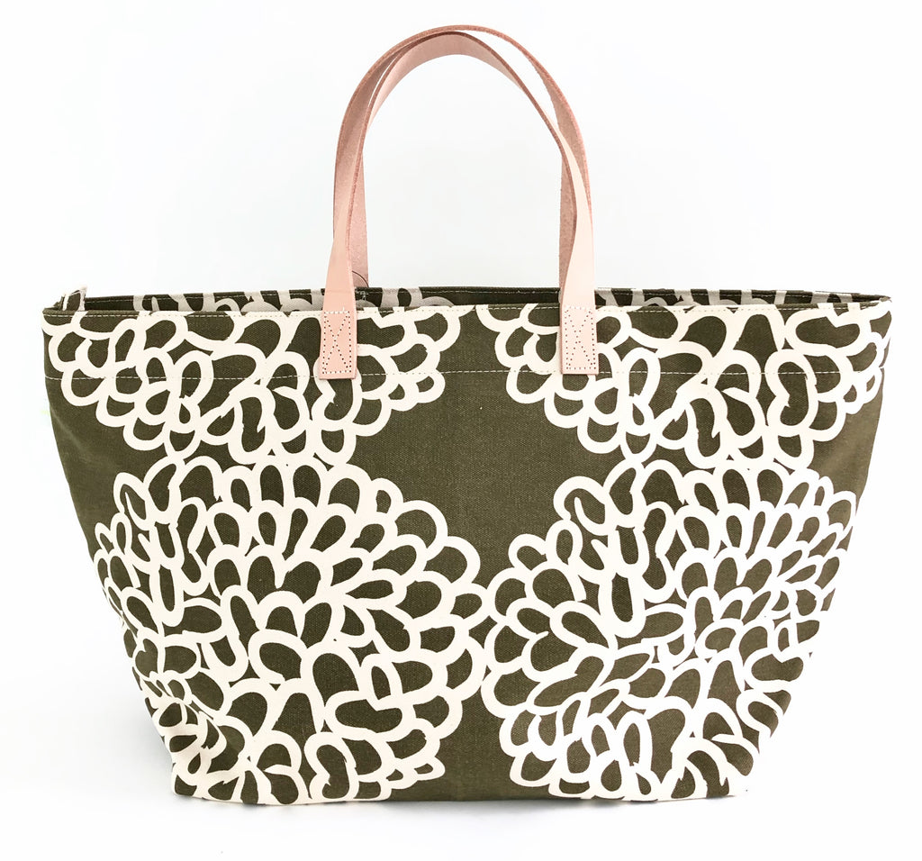 A green See Design Overnighter tote bag perfect for a weekend away.