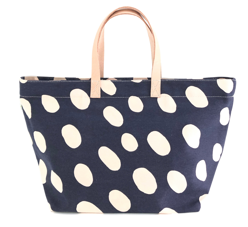 Navy and white polka dot See Design Overnighter tote bag.