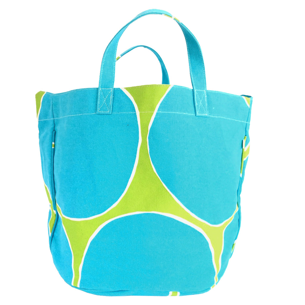 A sturdy See Design Circle Tote with printed blue circles and green circles on it.