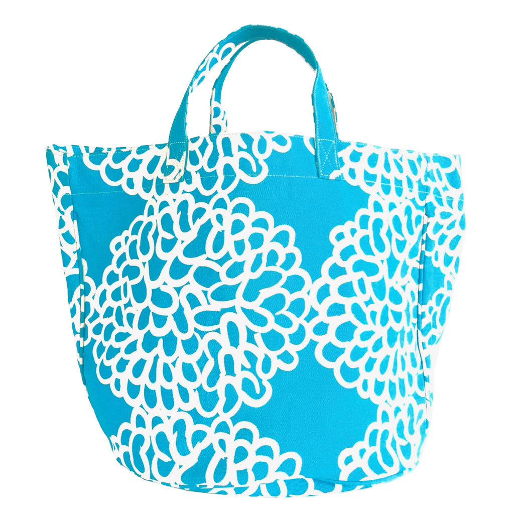A best-selling Circle Tote made of cotton canvas in a blue and white floral print by See Design.