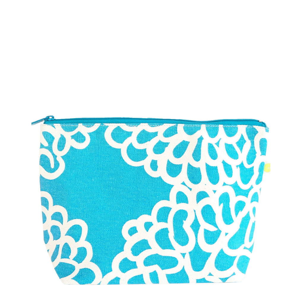 A large Travel Pouch Large with easy access to essentials, featuring blue and white design with white flowers from See Design.