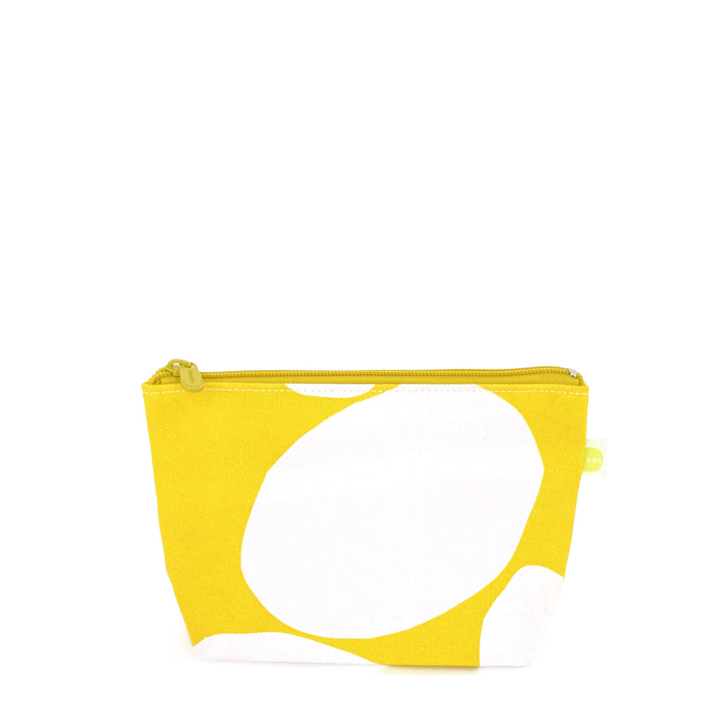 A compact Travel Pouch Small in yellow and white on a white background by See Design.