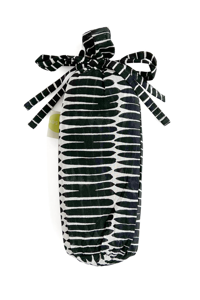 A fashionable black and white striped Sarong bag with a bow by See Design.