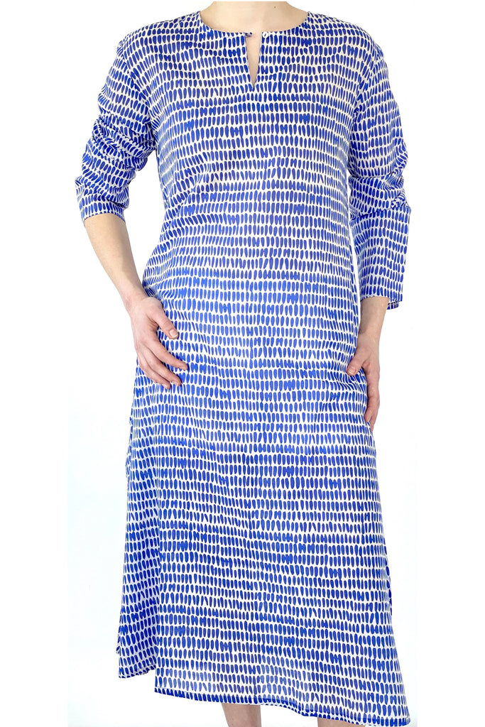 A woman wearing a lightweight and soft cotton voile See Design Tunic Full Length in a blue and white printed dress.