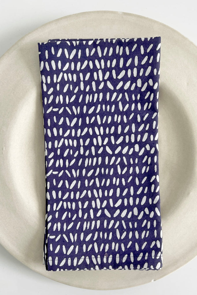 A blue and white cotton See Design napkins (Set of 4) on a plate.